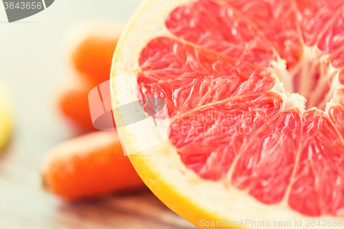 Image of close up of fresh juicy grapefruit slice on table