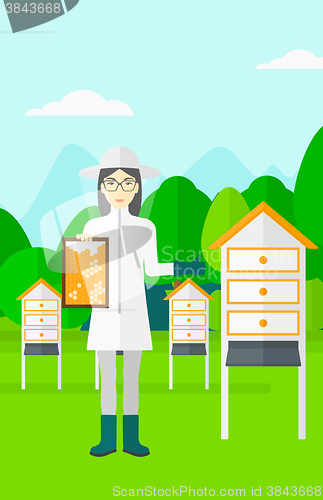 Image of Bee-keeper at apiary.