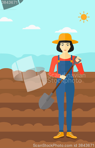 Image of Farmer on the field with shovel.