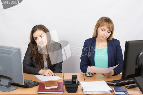 Image of Office Workers of despondently sitting at a desk