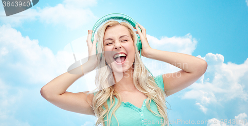 Image of happy young woman or teenage girl with headphones