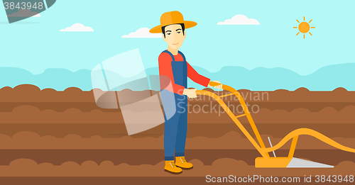 Image of Farmer on the field with plough.