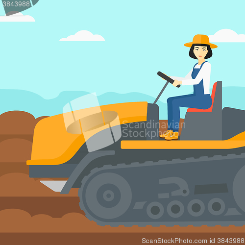 Image of Farmer driving tractor.