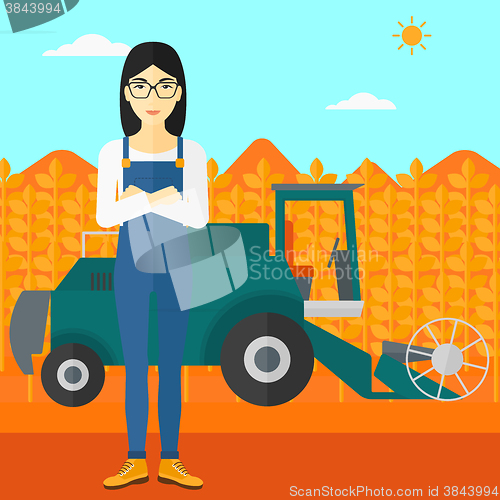 Image of Woman standing with combine on background.