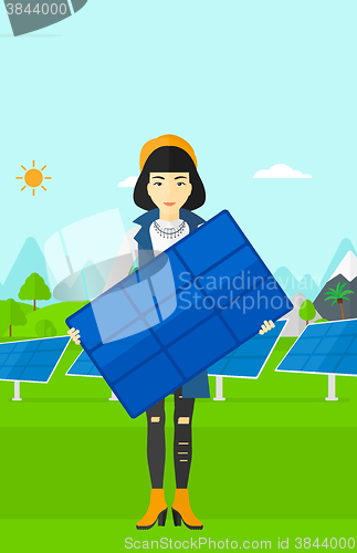 Image of Woman holding solar panel.