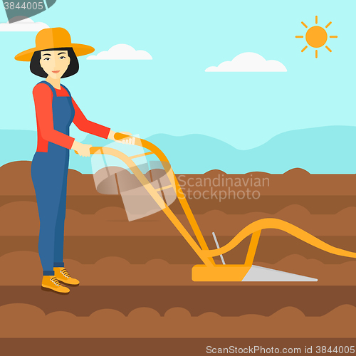 Image of Farmer on the field with plough.