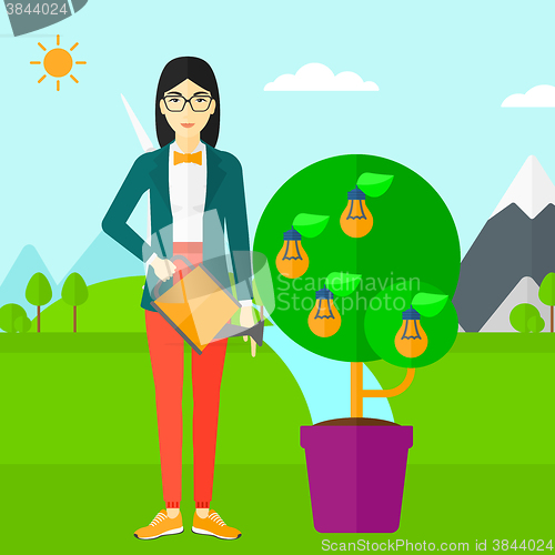 Image of Woman watering tree with light bulbs.