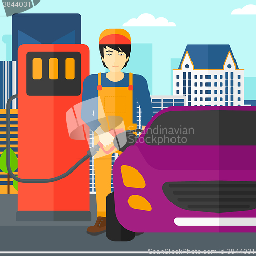 Image of Man filling up fuel into car.