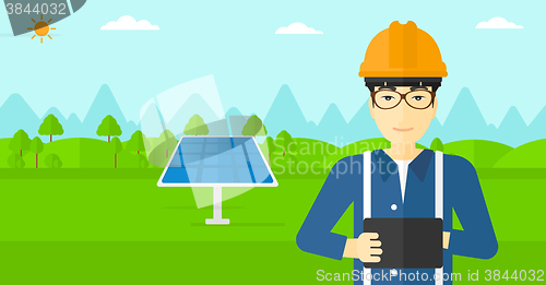 Image of Man holding tablet computer.