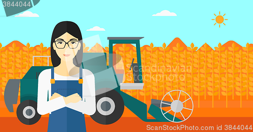 Image of Woman standing with combine on background.