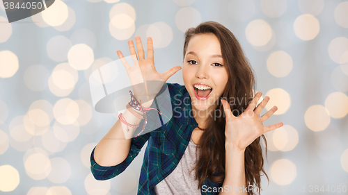 Image of happy laughing pretty teenage girl showing hands