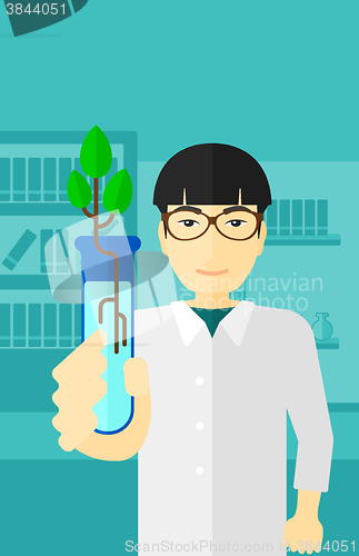 Image of Laboratory assistant with test tube.