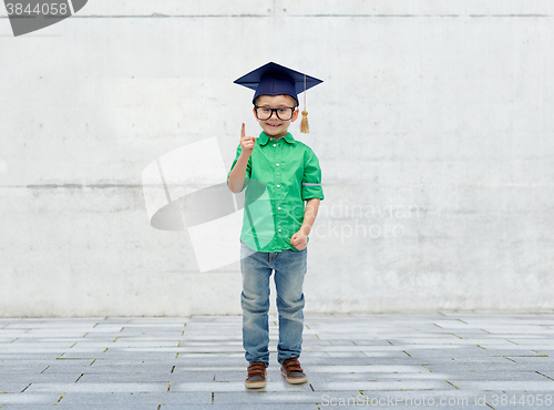 Image of happy boy in bachelor hat and eyeglasses