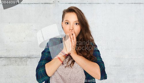Image of scared teenage girl over gray stone wall