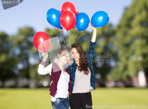 Image of happy teenage girls with helium balloons