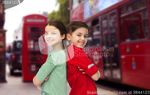 Image of happy boy and girl standing over london city