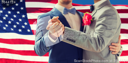 Image of close up of happy male gay couple dancing