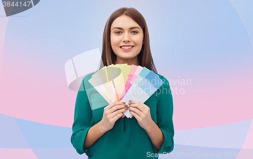 Image of smiling young woman with color swatches