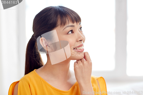 Image of happy asian young dreaming woman face at home