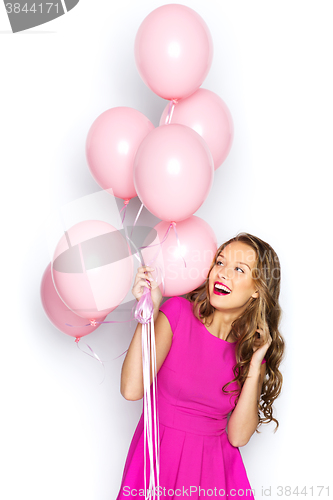 Image of happy young woman or teen girl in pink dress