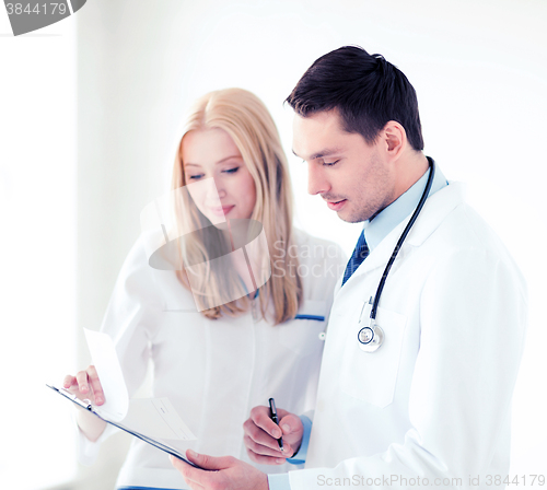 Image of two doctors writing prescription