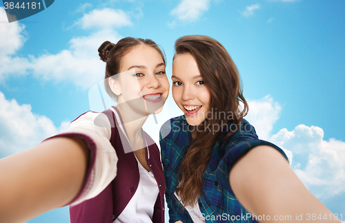 Image of happy smiling pretty teenage girls taking selfie