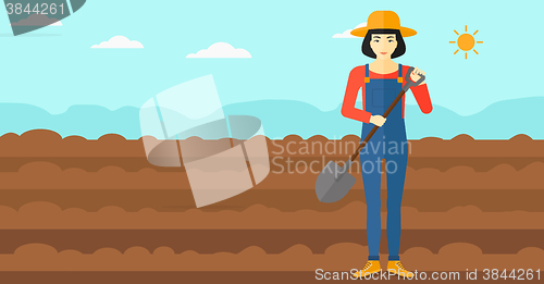 Image of Farmer on the field with shovel.