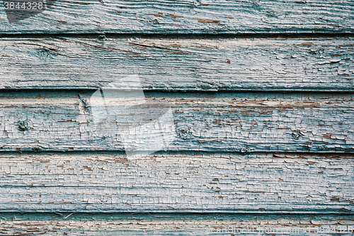 Image of Old blue cracked paint on wooden background