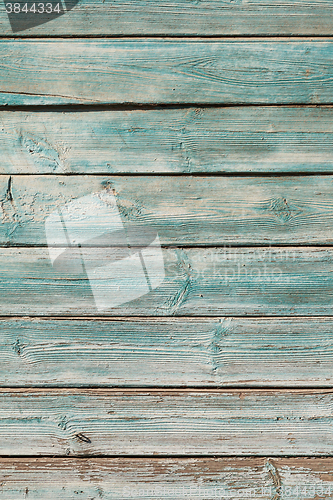 Image of Old blue cracked paint on wooden background