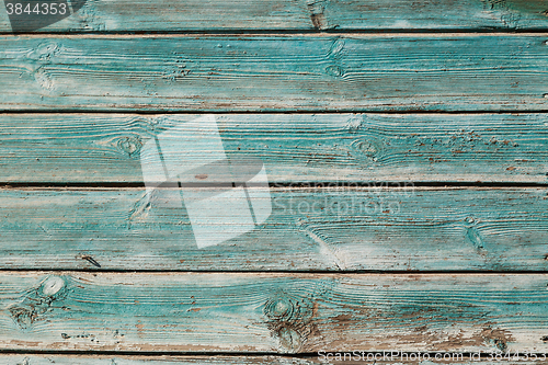 Image of Old blue cracked paint on wooden background