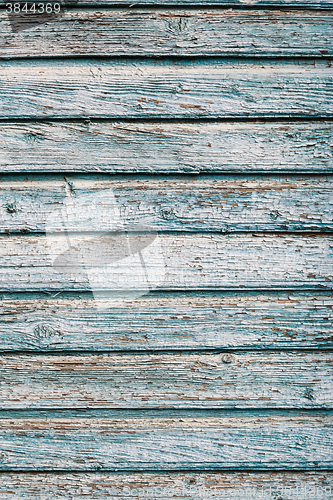 Image of Old blue cracked paint on wooden background