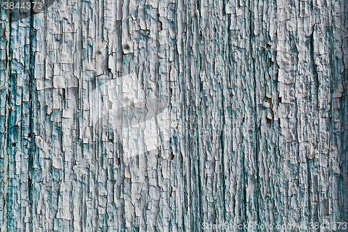 Image of Old blue cracked paint on wooden background
