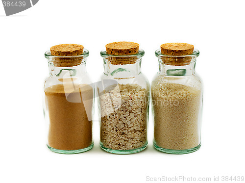 Image of three glass bottles filled with sand