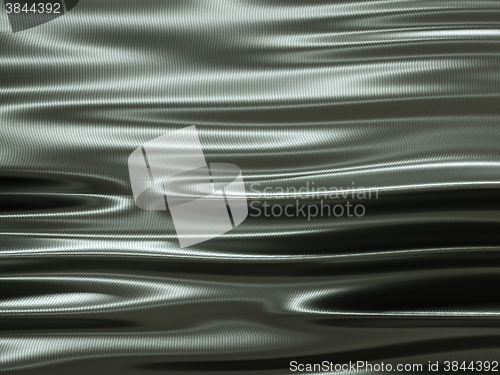 Image of metallic cloth with waves and ripples