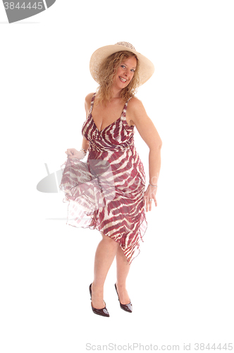 Image of Happy blond woman dancing.