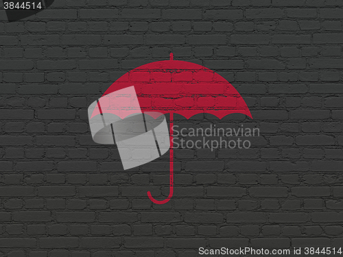 Image of Security concept: Umbrella on wall background