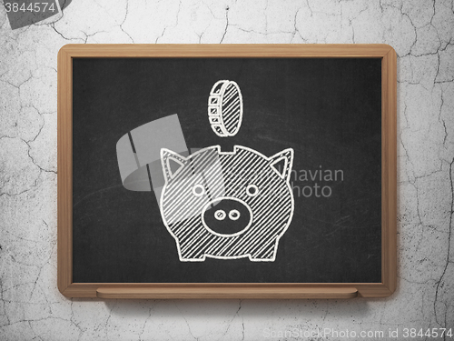Image of Banking concept: Money Box With Coin on chalkboard background