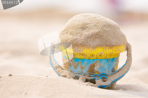 Image of Childrens bucket with sand on the beach