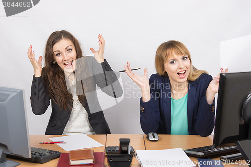 Image of Two employee in the office expressed elation
