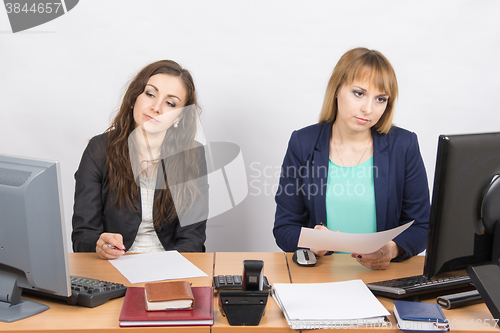 Image of Employees of the office sitting at a desk with a view of the downtrodden