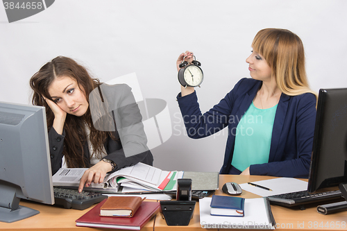Image of Waiting for the end of working hours by two employees of the office