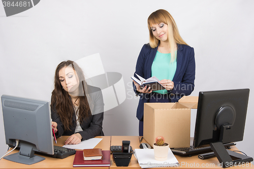 Image of An employee in the office happily lays out things about colleagues