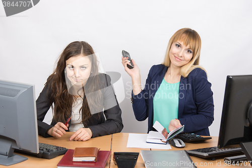 Image of Positive girl in the office with a phone in his hand close to the negative counterpart