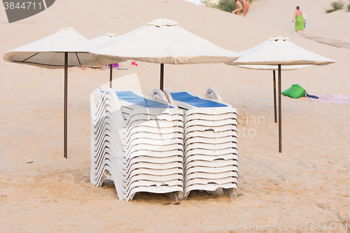 Image of Collected in piles on the beach chairs under umbrellas