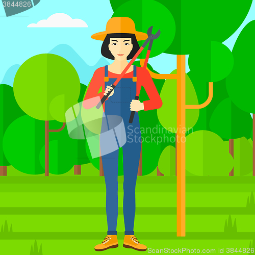 Image of Farmer with pruner in garden.