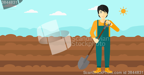 Image of Farmer on the field with shovel.