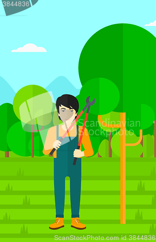 Image of Farmer with pruner in garden.