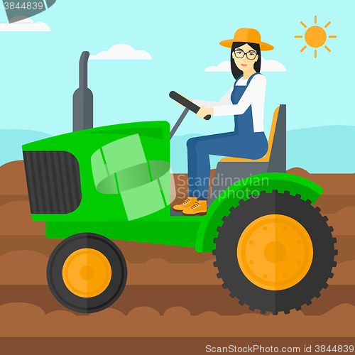 Image of Farmer driving tractor.