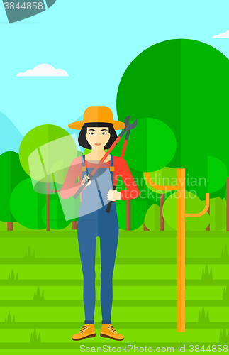 Image of Farmer with pruner in garden.