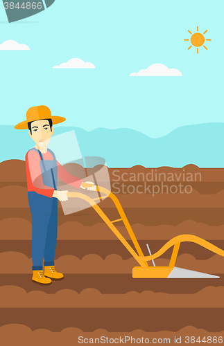 Image of Farmer on the field with plough.